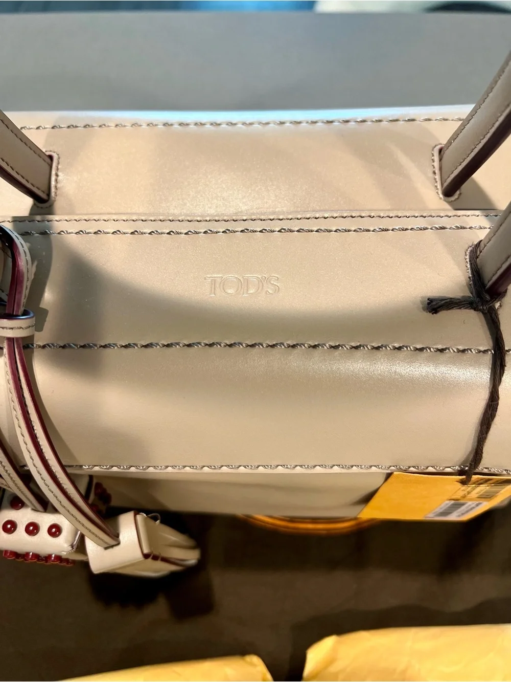 TOD'S structured satchel in delicate leather featuring contrast dark red trim